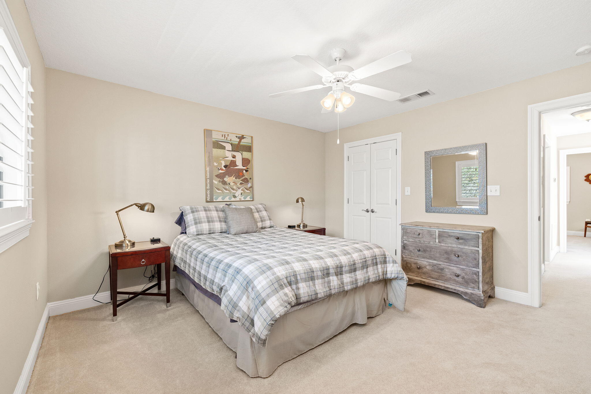 100 Gleneagles Drive Niceville, FL 32578 - Photo 34 of 60 a bedroom with a bed and a chandelier