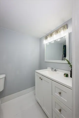 a bathroom with a sink vanity and mirror