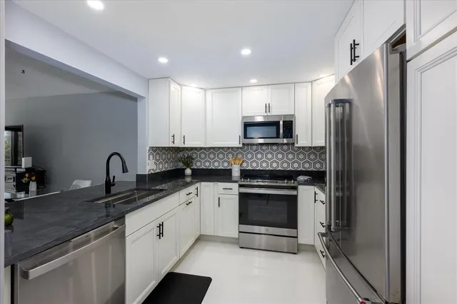 a kitchen with a sink stove and refrigerator