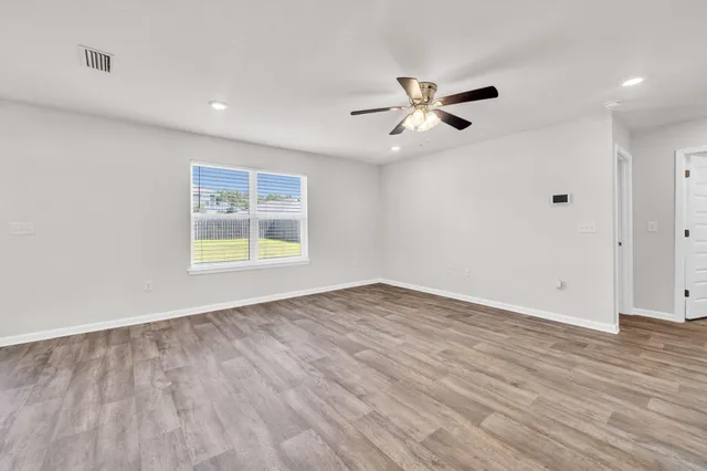 wooden floor in an empty room with a window