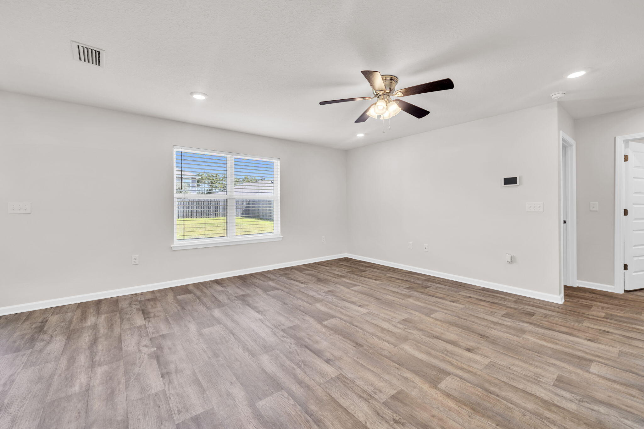 305 This Way Freeport, FL 32439 - Photo 11 of 48 wooden floor in an empty room with a window