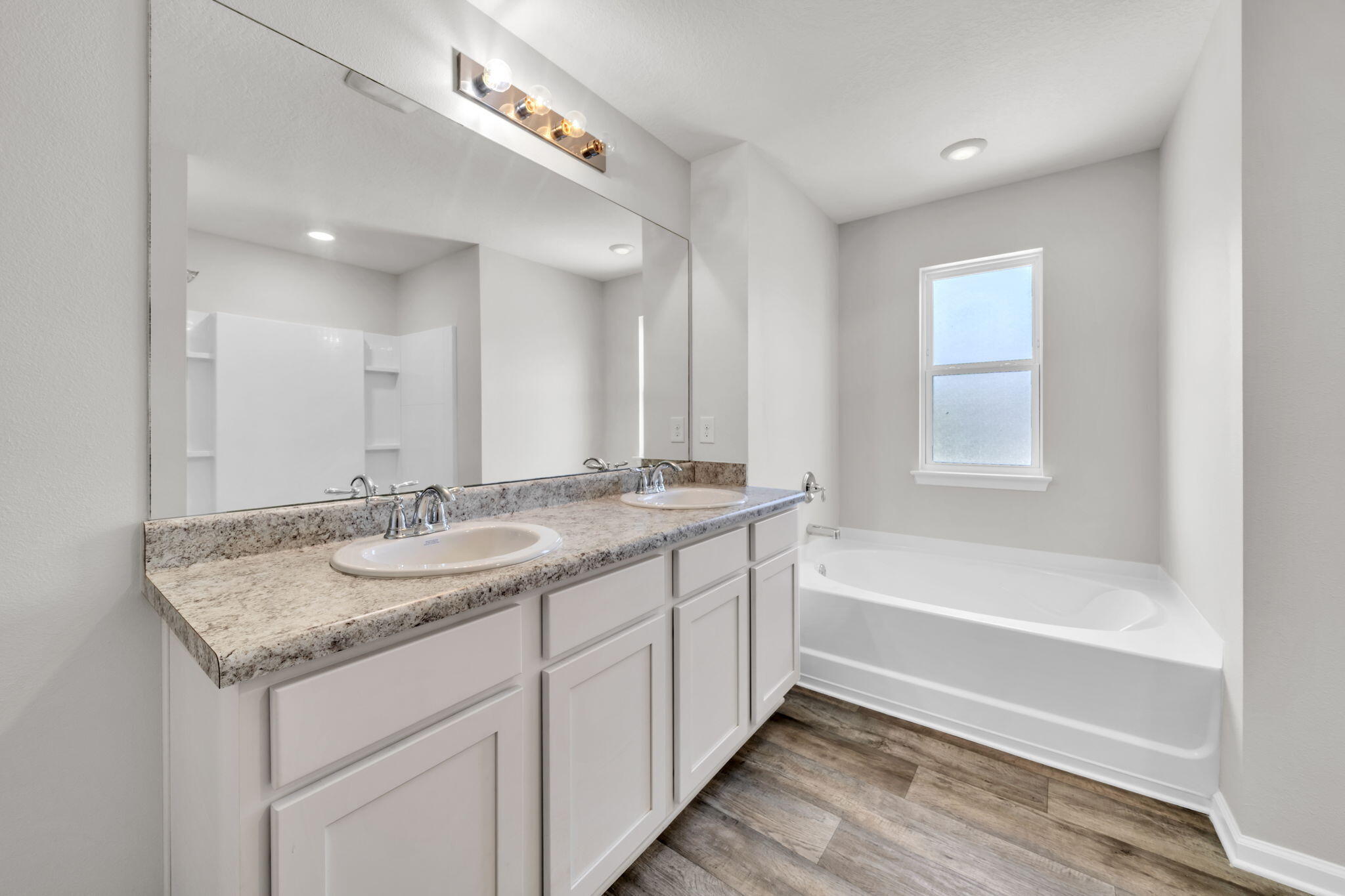 305 This Way Freeport, FL 32439 - Photo 20 of 48 a bathroom with a granite countertop sink a large mirror and a bathtub