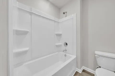 a bathroom with a bathtub and a toilet