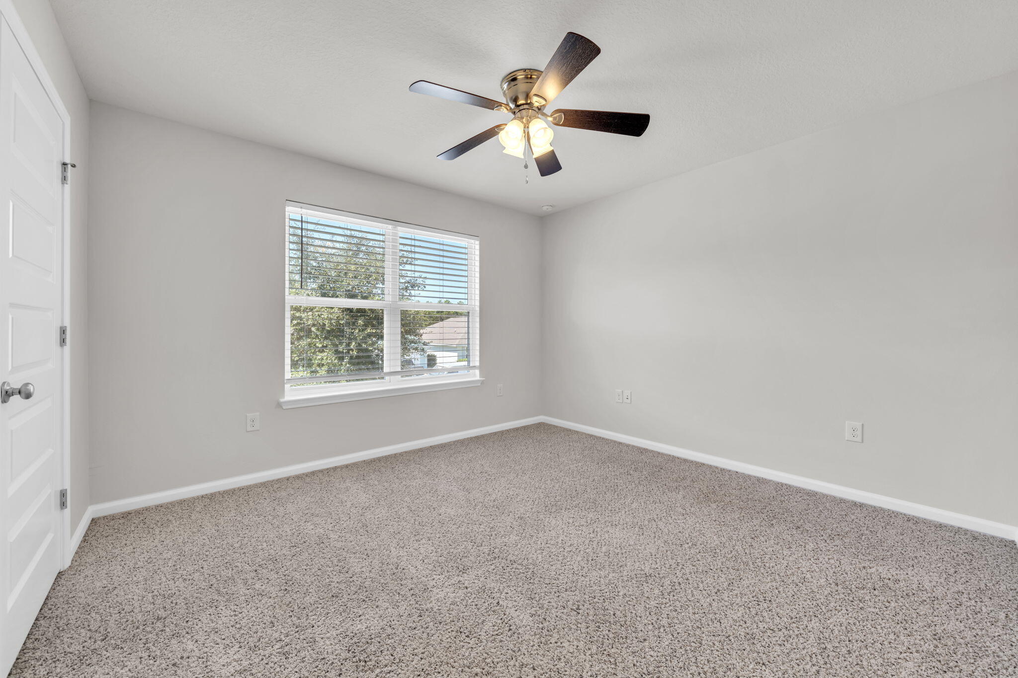 305 This Way Freeport, FL 32439 - Photo 28 of 48 an empty room with ceiling fan and windows