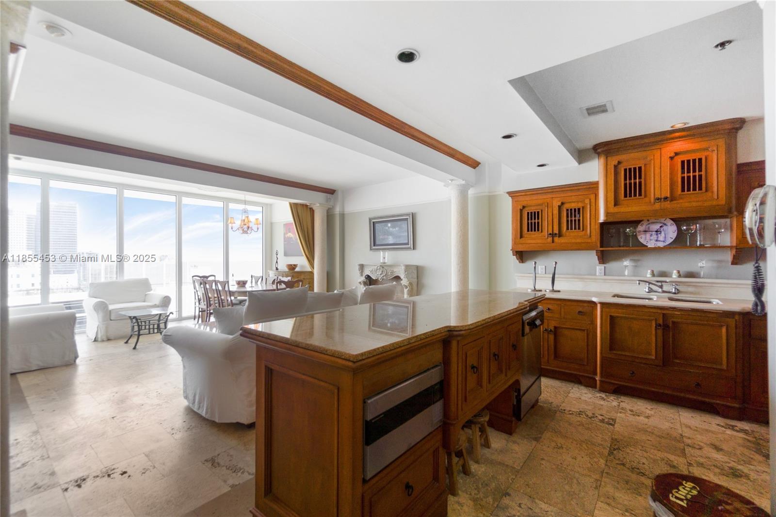 100 Lincoln Road, Unit PH8 Miami Beach, FL 33139 - Photo 13 of 37 a large living room with stainless steel appliances granite countertop a sink dishwasher a stove and a dining table with wooden floor
