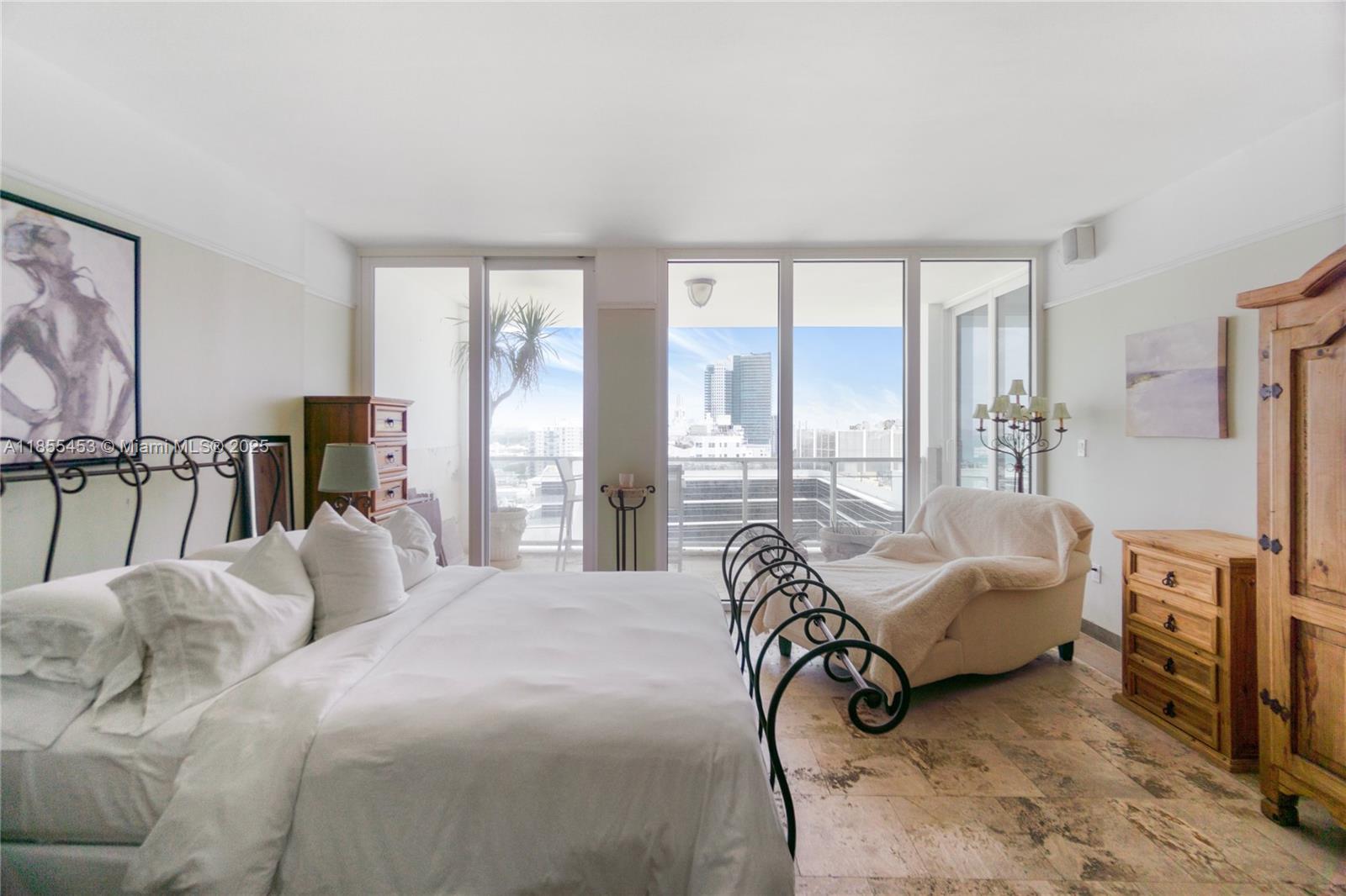 100 Lincoln Road, Unit PH8 Miami Beach, FL 33139 - Photo 17 of 37 a bedroom with furniture and a flat screen tv