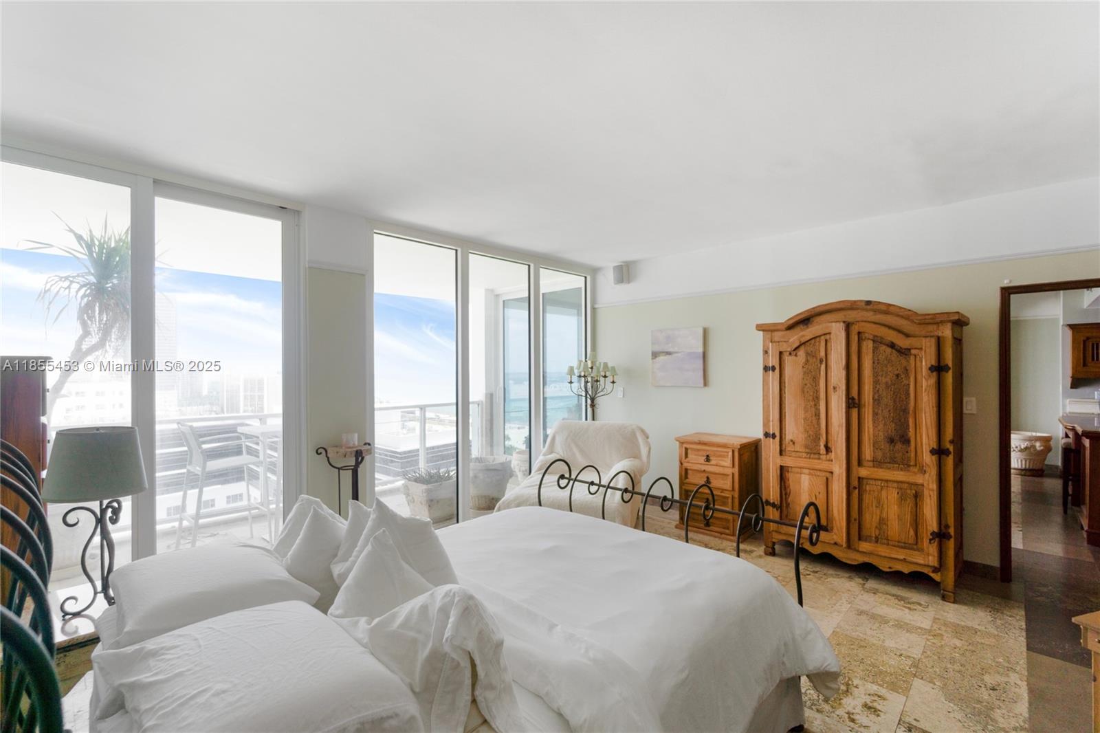 100 Lincoln Road, Unit PH8 Miami Beach, FL 33139 - Photo 18 of 37 a bedroom with furniture and large windows