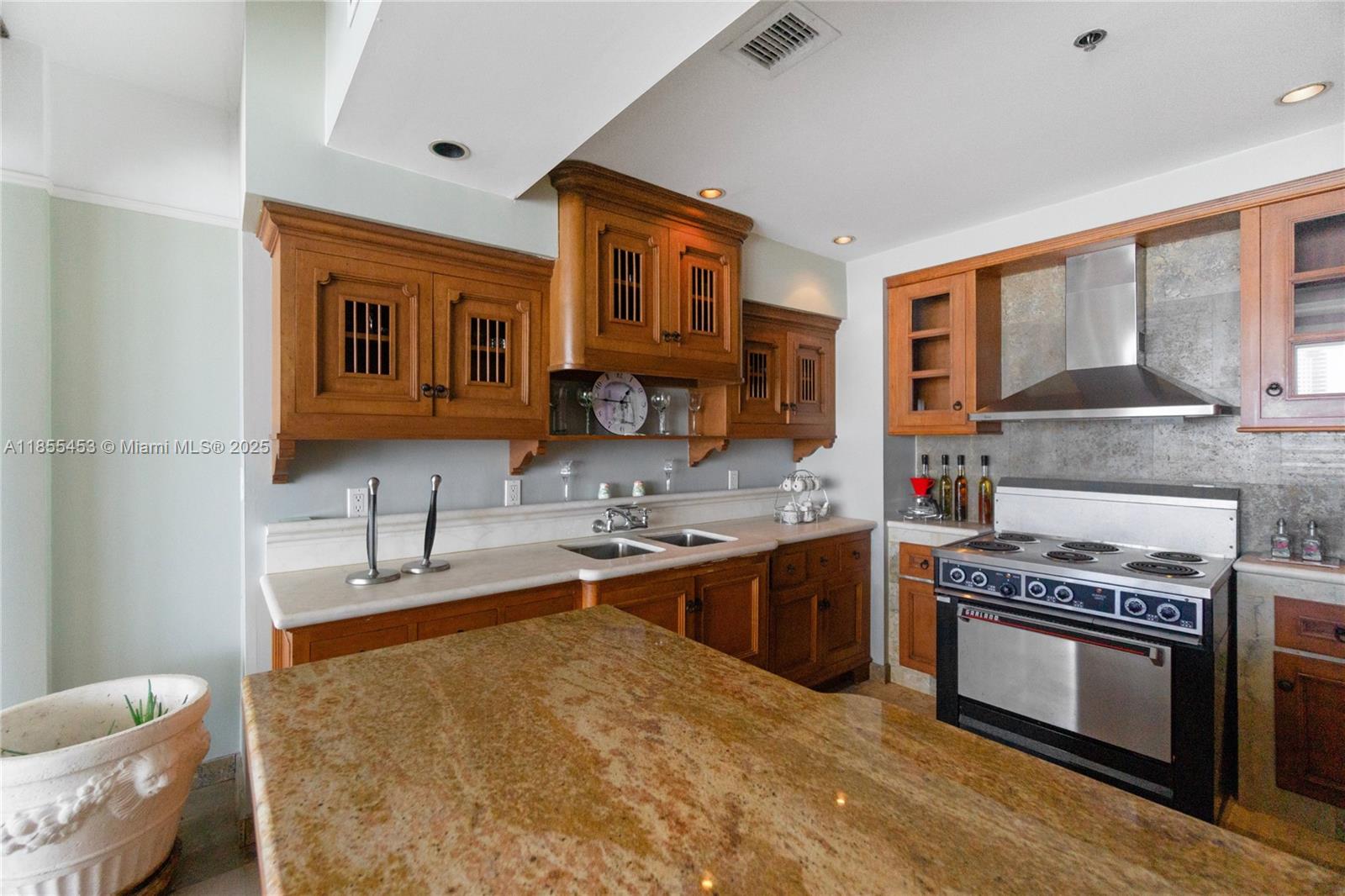 100 Lincoln Road, Unit PH8 Miami Beach, FL 33139 - Photo 4 of 37 a kitchen with stainless steel appliances granite countertop a stove and a sink