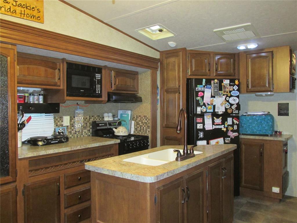 24 Saddle Bag Road Lake Wales, FL 33898 - Photo 3 of 18 Very functional kitchen, with island for extra workspace!