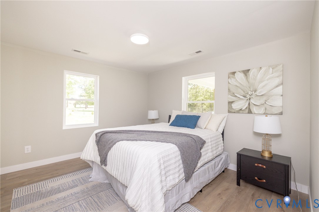 7272 Willson Road Henrico, VA 23231 - Photo 27 of 47 a bedroom with a bed and a painting on the wall