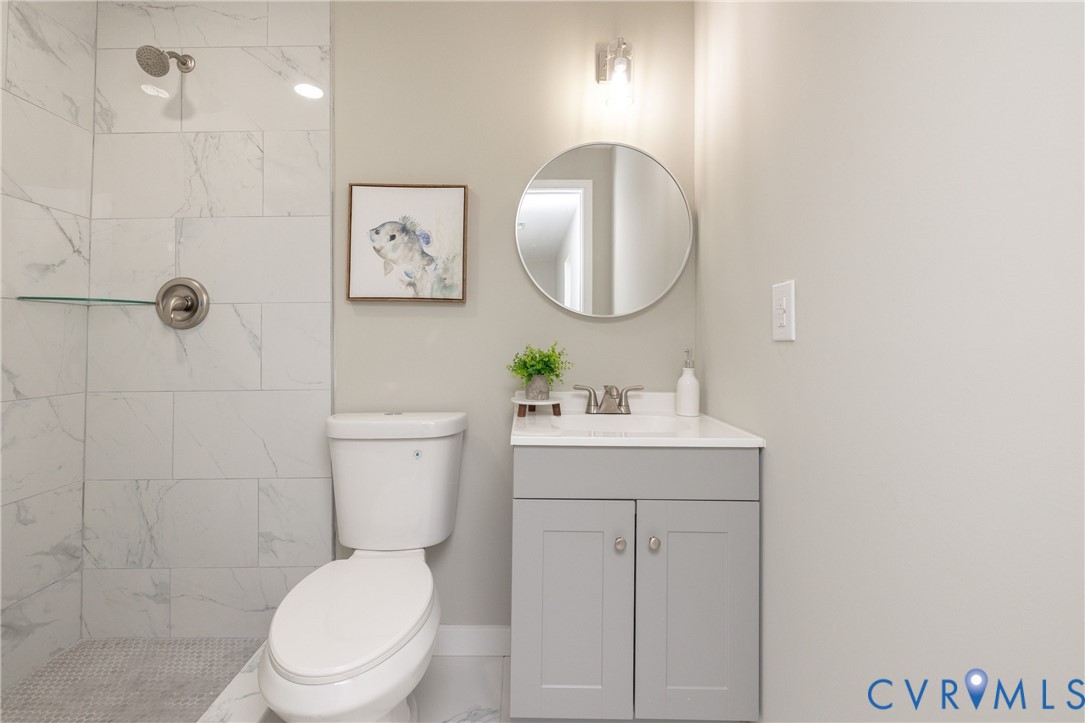 7272 Willson Road Henrico, VA 23231 - Photo 29 of 47 Bathroom featuring vanity, marble look tiles, and