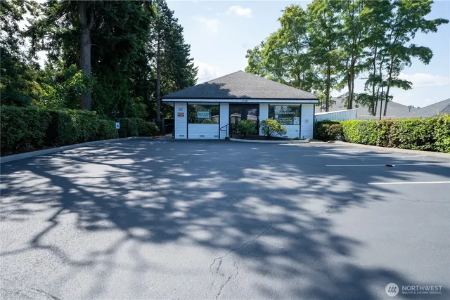 a front view of a house with yard and green space