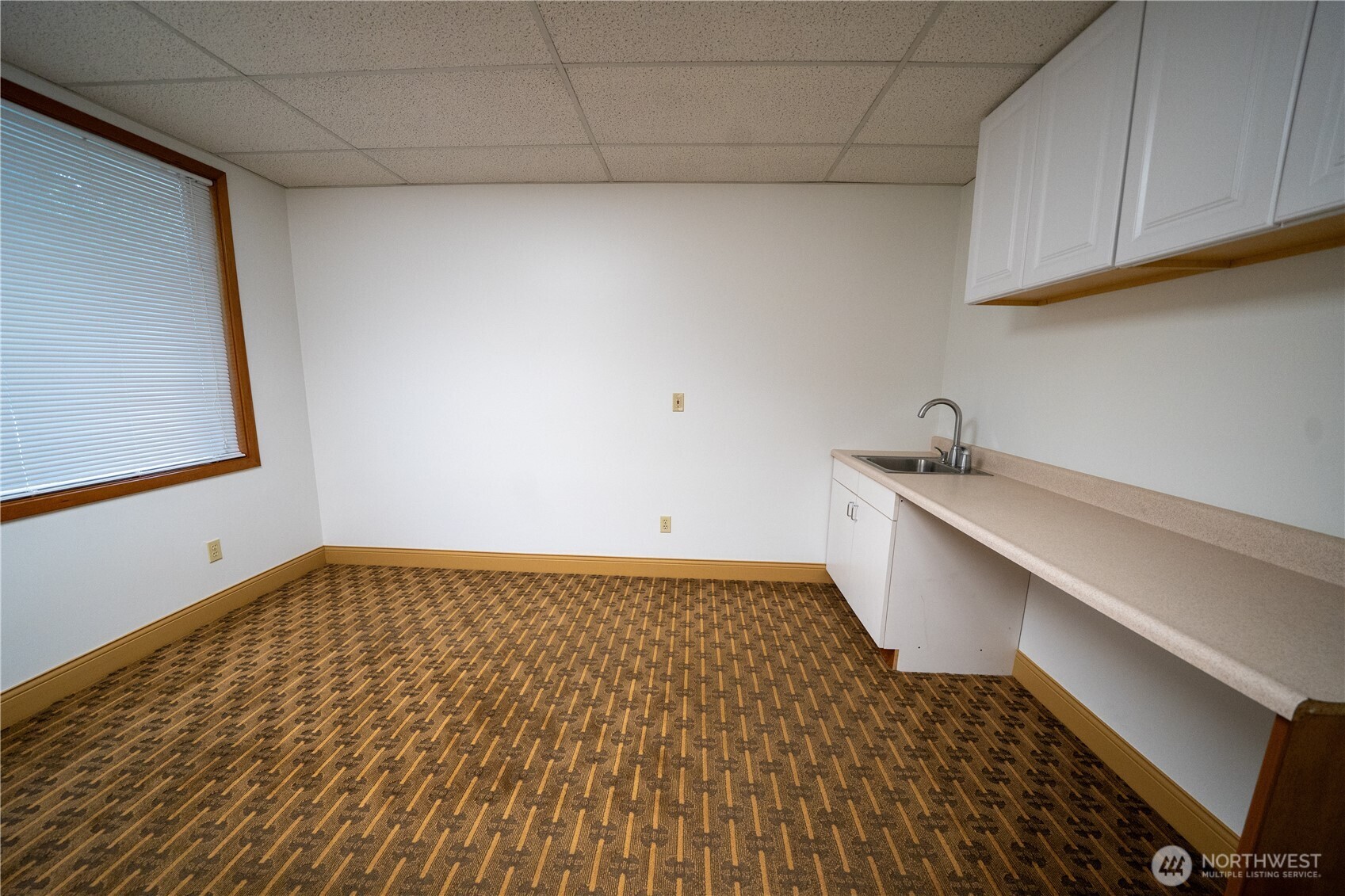 11201 Southeast Kent-Kangley Road, Unit 103 Kent, WA 98030 - Photo 7 of 9 a view of a room with wooden floor and cabinet