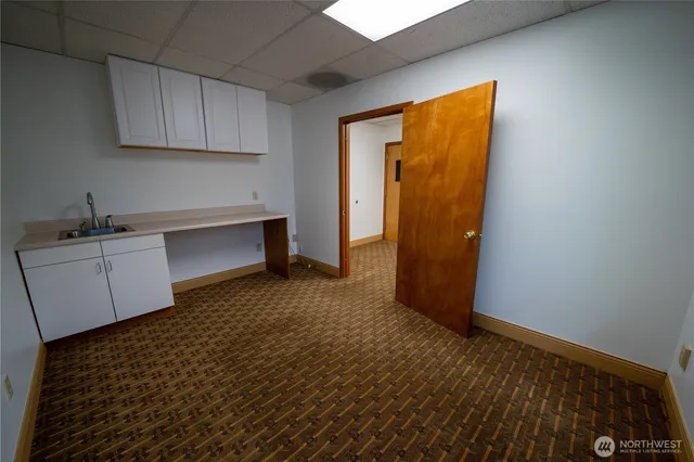 a room with a sink and cabinets