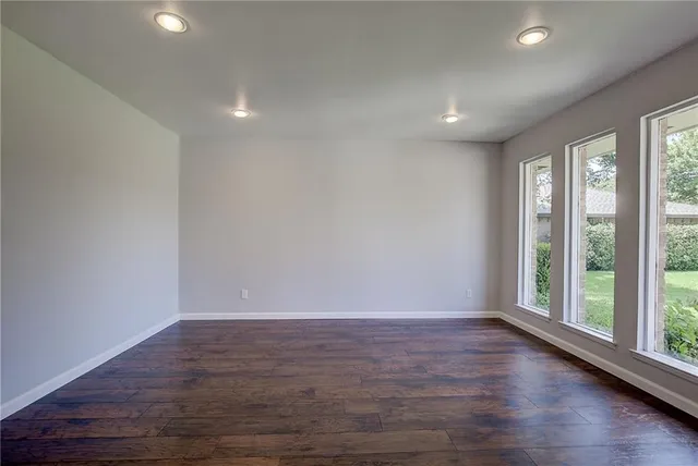 a view of room with window and wooden floor