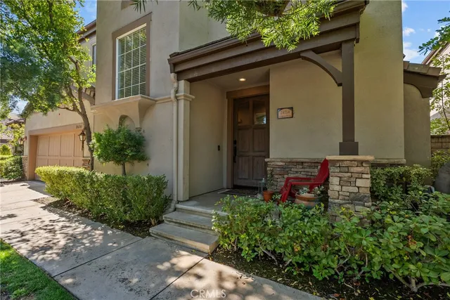 a backyard of a house with plants and outdoor seating