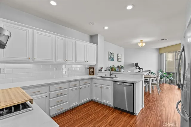a kitchen with a sink cabinets and wooden floor