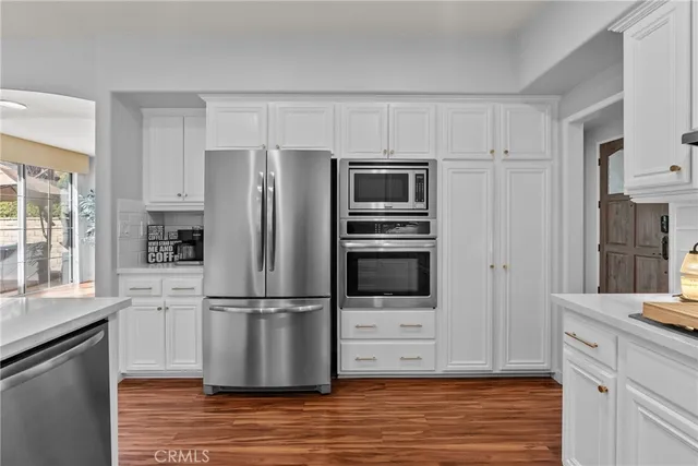 a kitchen with wooden cabinets and stainless steel appliances