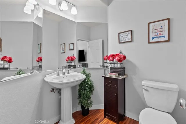 a bathroom with a sink mirror vanity and toilet