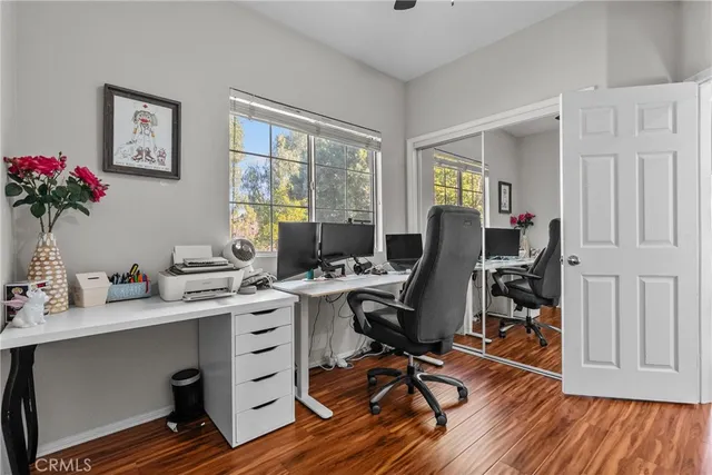 a view of a workspace with furniture and a window