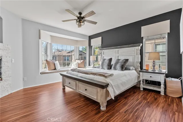 a bedroom with a bed and a large window