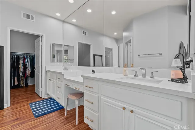 a bathroom with a sink double vanity and a large mirror