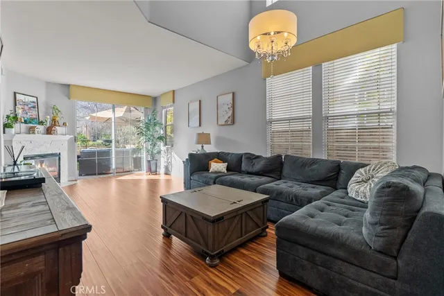 a living room with furniture and a chandelier