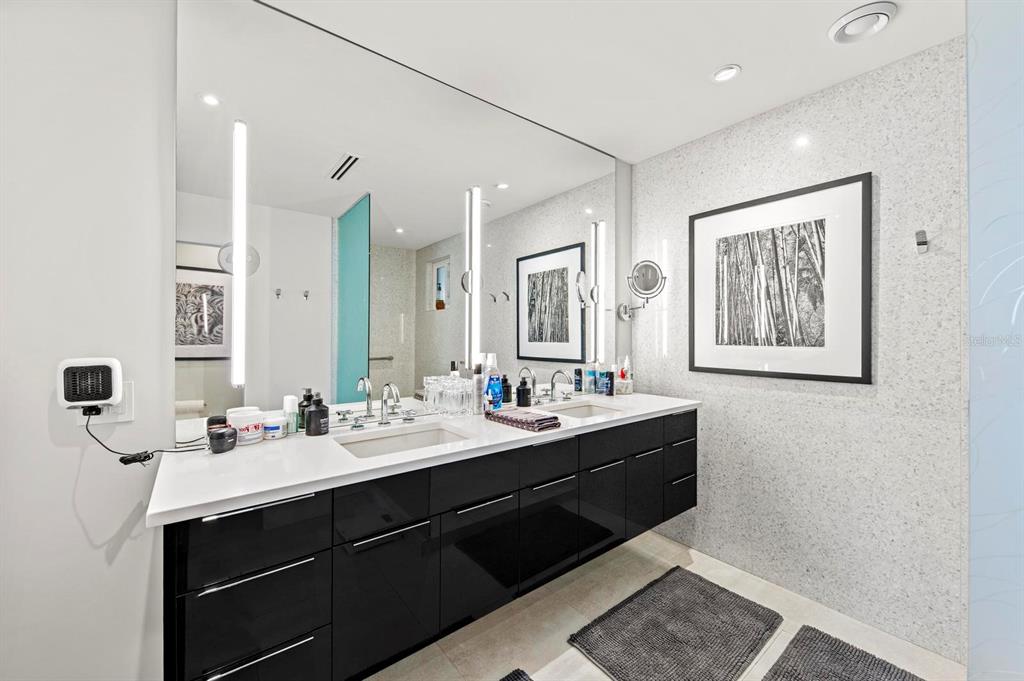 226 Golden Gate Point, Unit 33 Sarasota, FL 34236 - Photo 19 of 39 a bathroom with a sink double vanity and a mirror