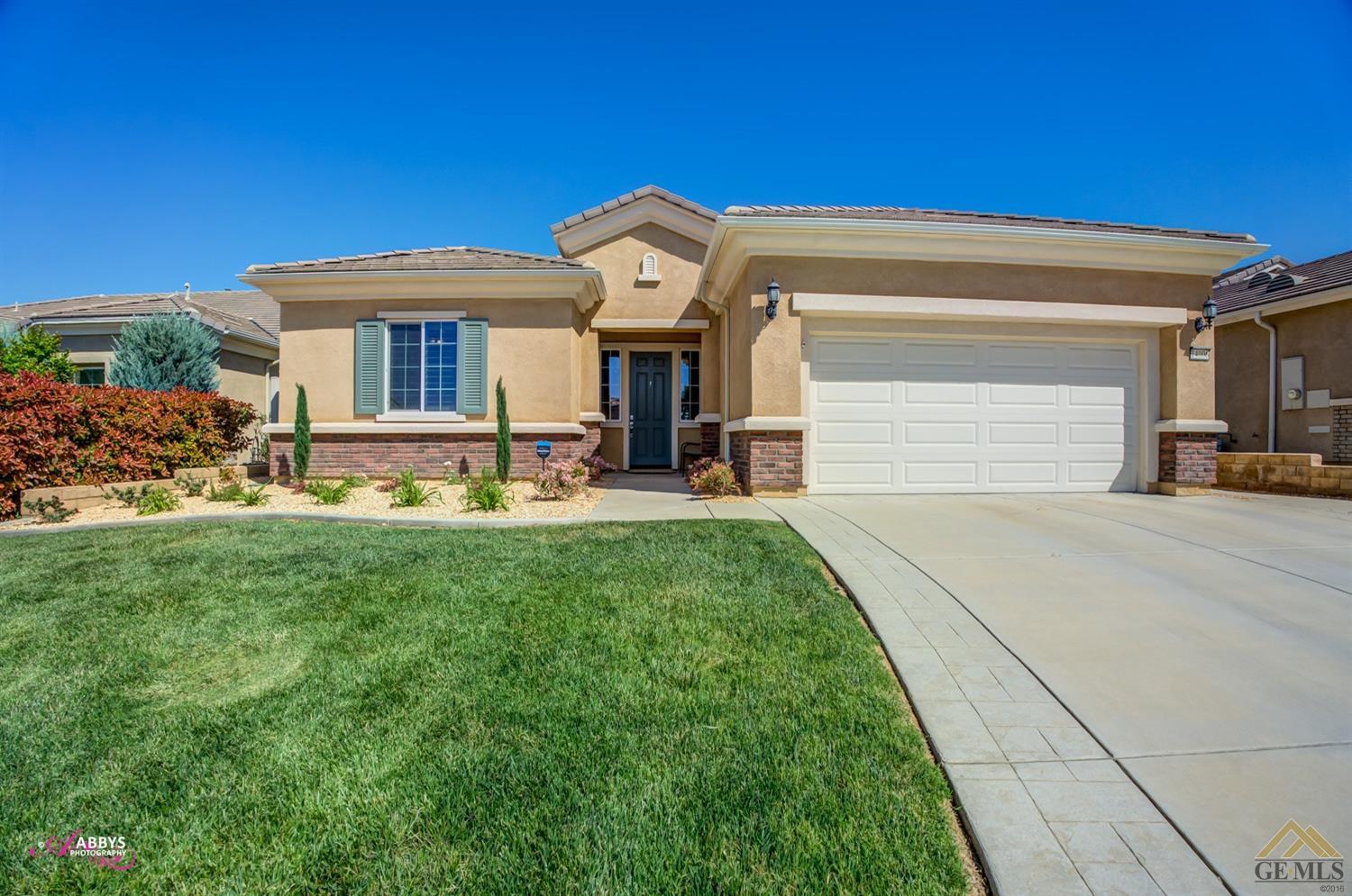 Undisclosed Address Bakersfield, CA 93306 - Photo 1 of 48 a front view of a house with garden