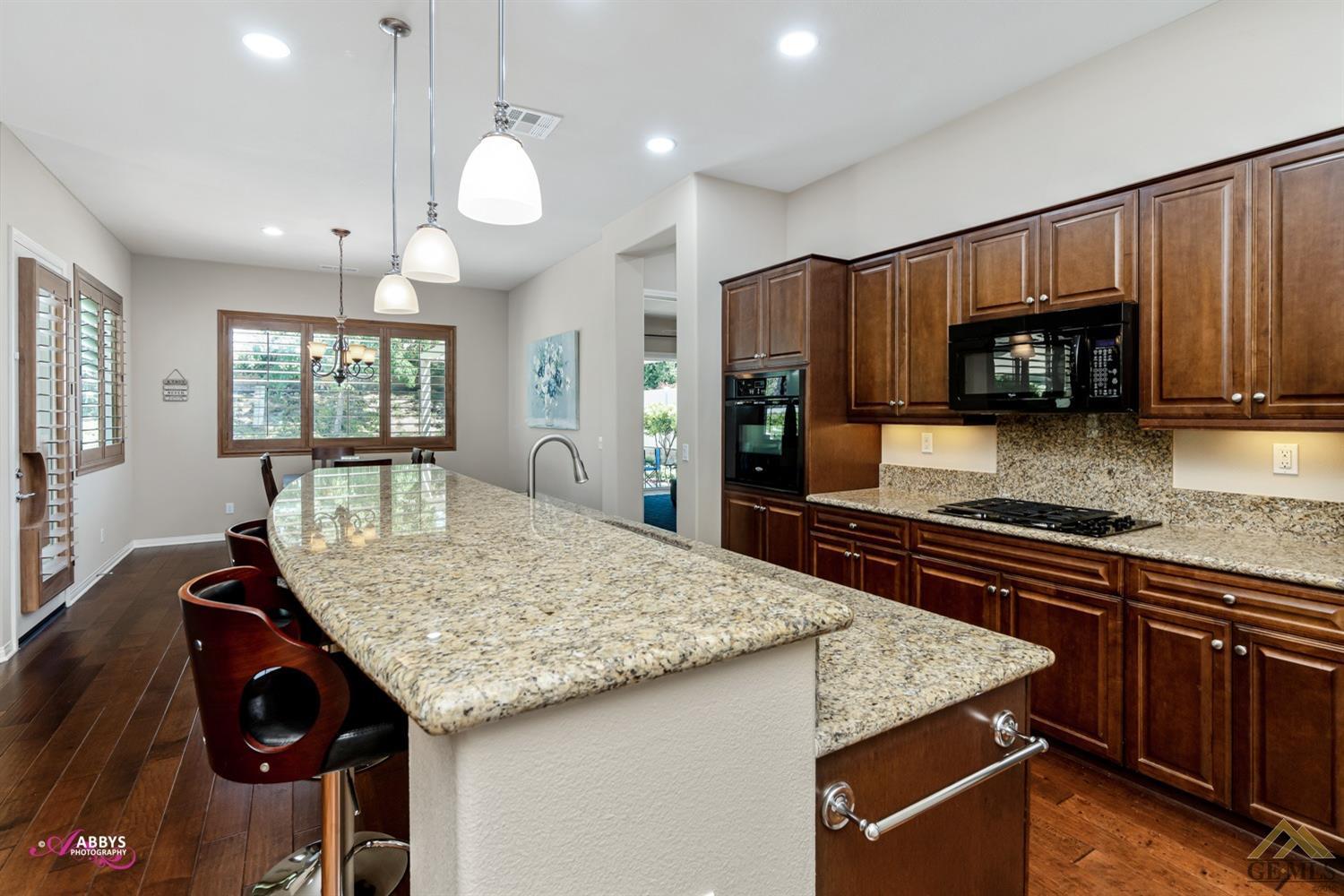 Undisclosed Address Bakersfield, CA 93306 - Photo 13 of 48 a kitchen with stainless steel appliances granite countertop a stove refrigerator and microwave