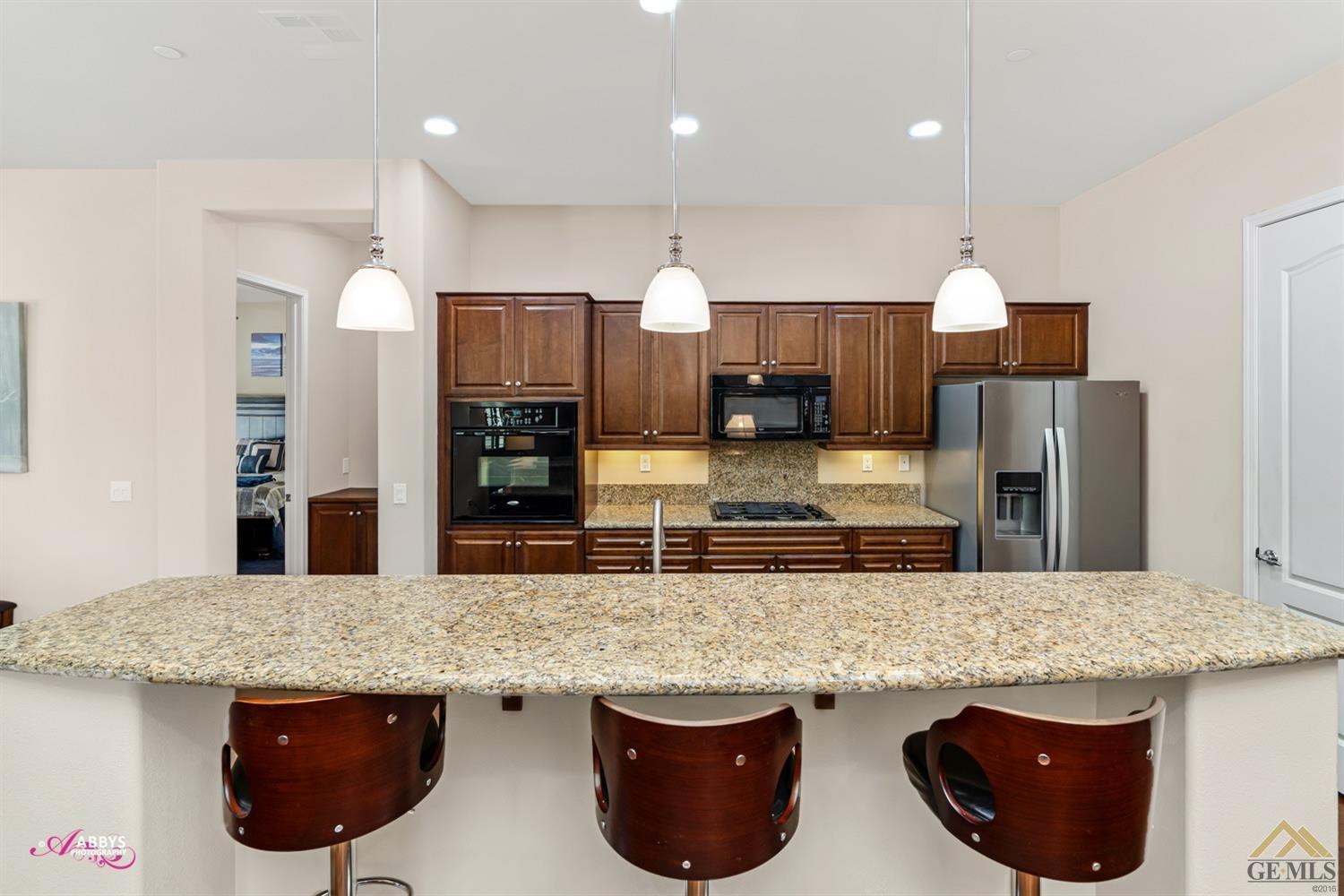 Undisclosed Address Bakersfield, CA 93306 - Photo 15 of 48 a kitchen with stainless steel appliances granite countertop a stove a sink and a microwave