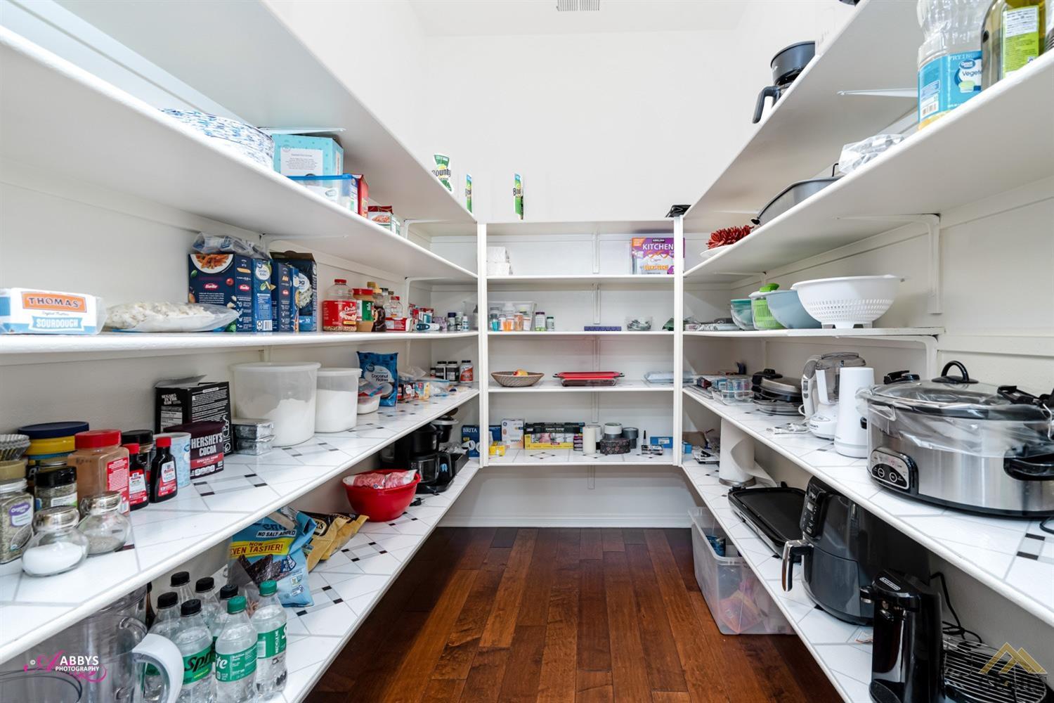 Undisclosed Address Bakersfield, CA 93306 - Photo 16 of 48 a kitchen with lots of counter top space and stainless steel appliances