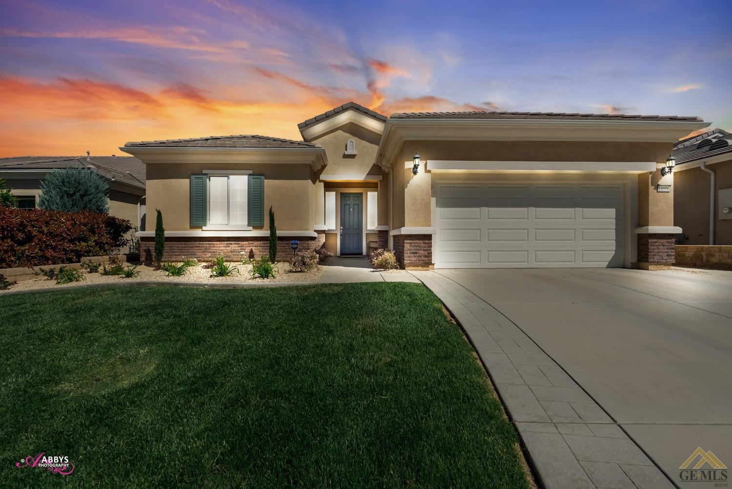 Undisclosed Address Bakersfield, CA 93306 - Photo 2 of 48 a front view of a house with a yard