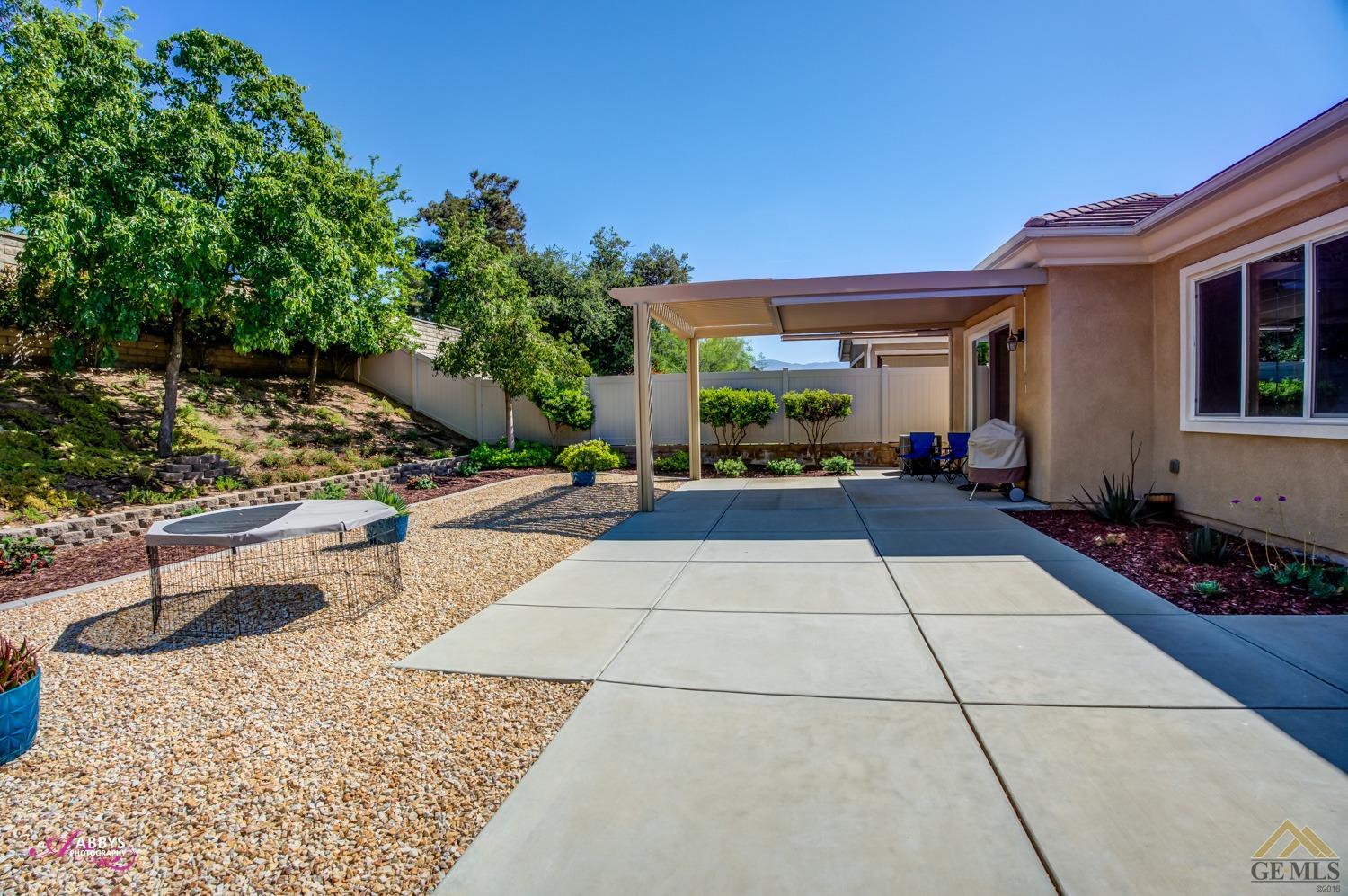 Undisclosed Address Bakersfield, CA 93306 - Photo 27 of 48 a backyard of a house with yard and outdoor seating