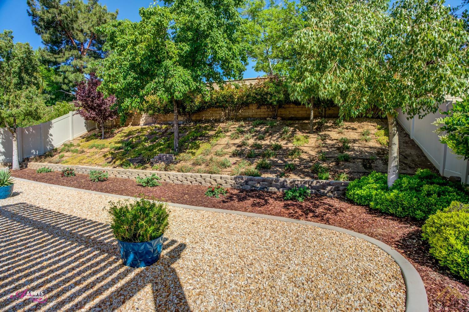 Undisclosed Address Bakersfield, CA 93306 - Photo 30 of 48 a view of a garden with flowers