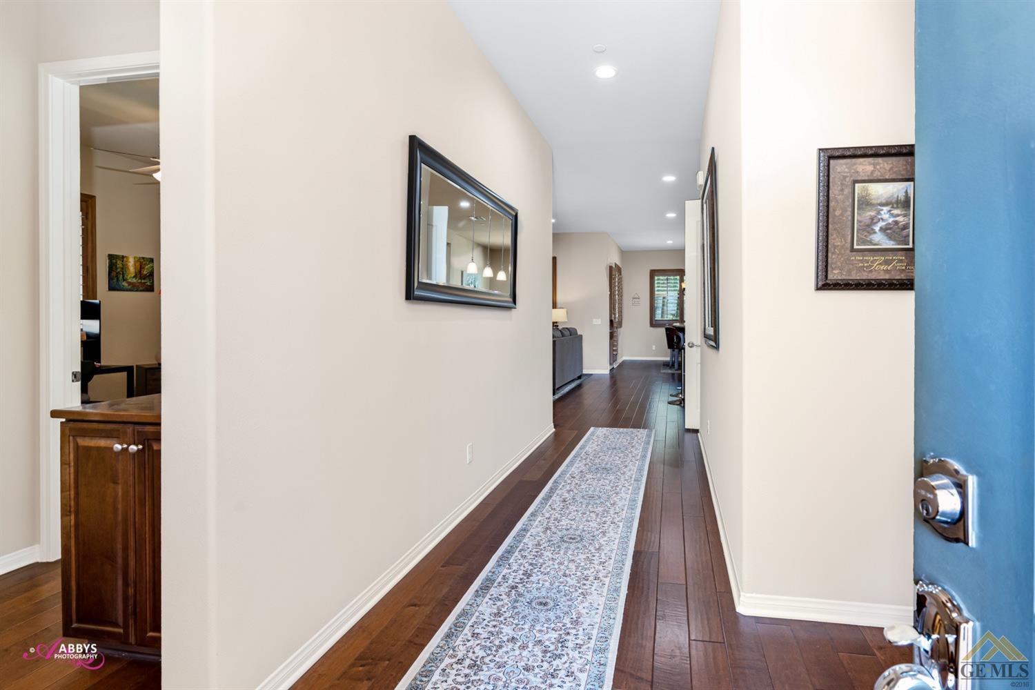 Undisclosed Address Bakersfield, CA 93306 - Photo 5 of 48 a view of a hallway with wooden floor and a bathroom