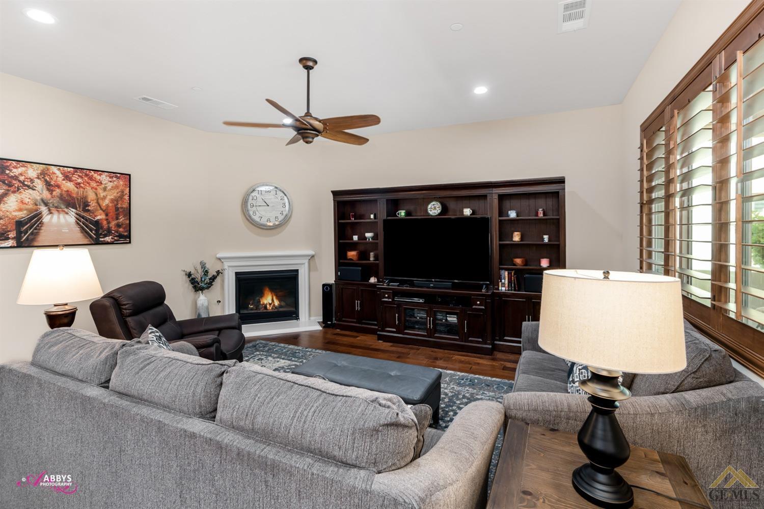 Undisclosed Address Bakersfield, CA 93306 - Photo 8 of 48 a living room with furniture a flat screen tv and a fireplace