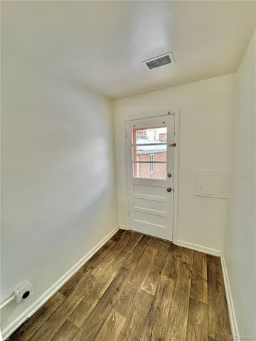 en empty room with windows and fan