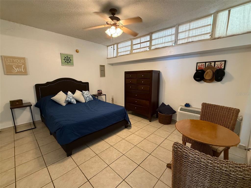 Condo Pelican Reef Condo Pelican Reef, Unit 302 Rincon, PR 00677 - Photo 5 of 16 a living room with furniture and a flat screen tv