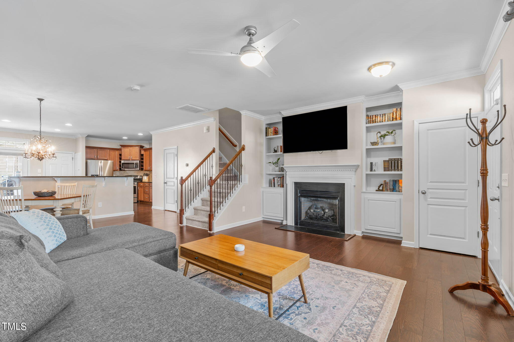 1307 Still Monument Way Raleigh, NC 27603 - Photo 3 of 40 a living room with furniture a flat screen tv and a fireplace
