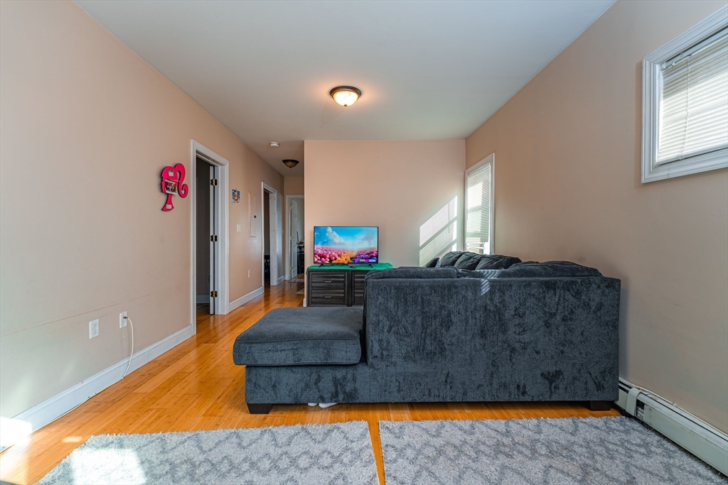 16 Mohan Street Everett, MA 02149 - Photo 16 of 35 a living room with furniture and a flat screen tv