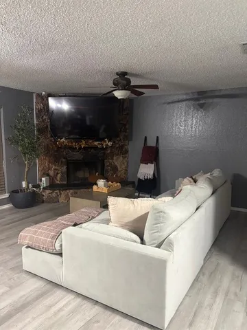 a living room with furniture and a lamp