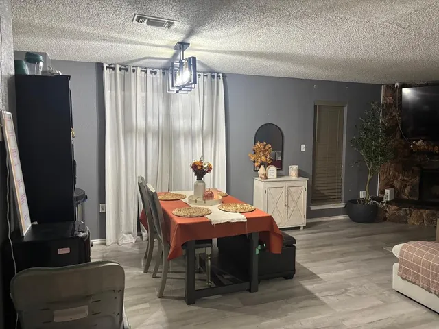 a living room with furniture a flat screen tv and a large window