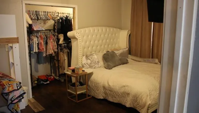 a bedroom with a bed and a mirror