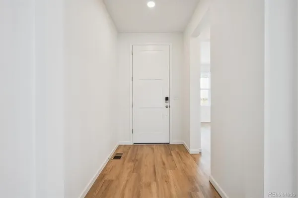 a view of a room with wooden floor