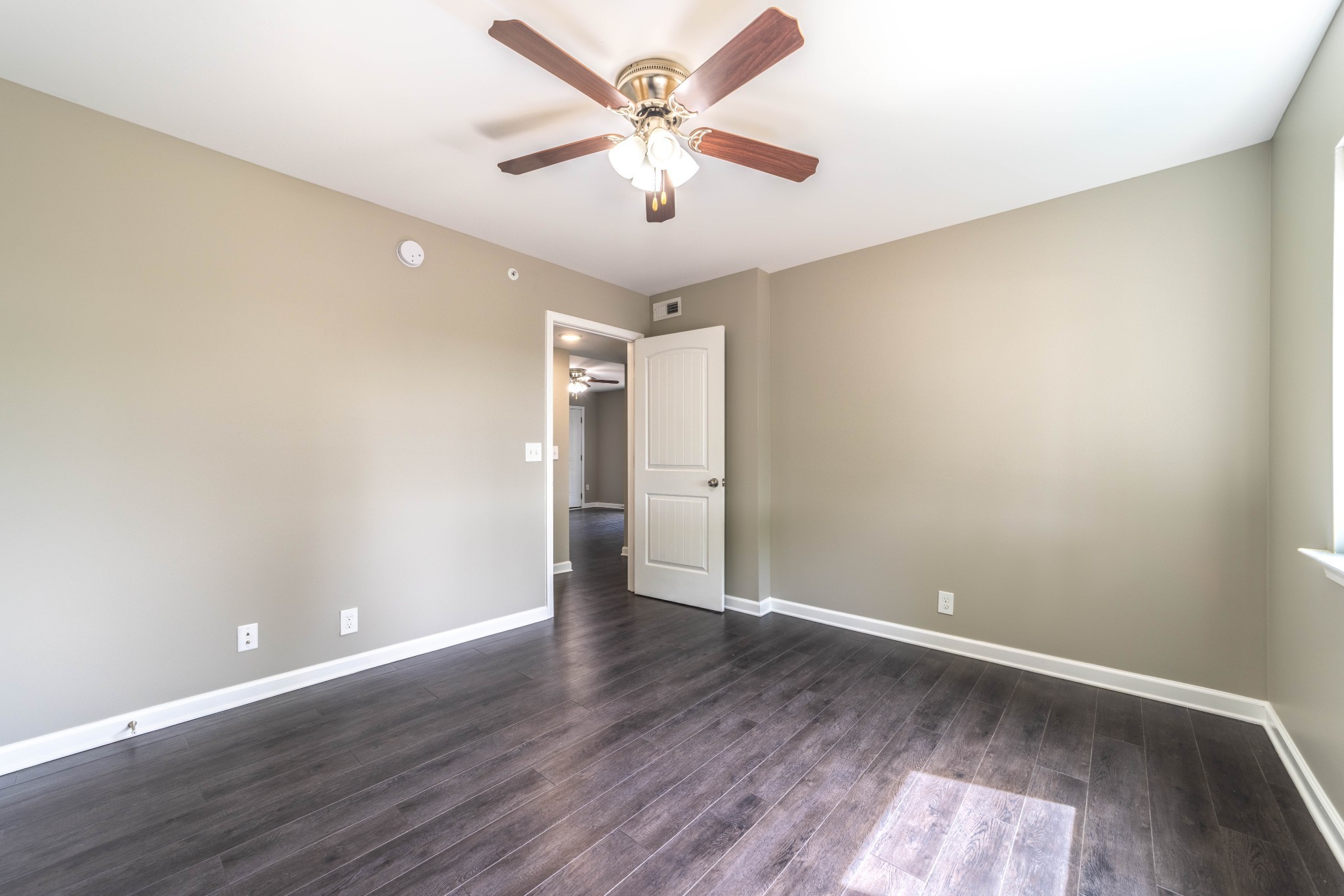 311 Hawkins Road, Unit H7 Clarksville, TN 37040 - Photo 7 of 15 an empty room with wooden floor and ceiling fan