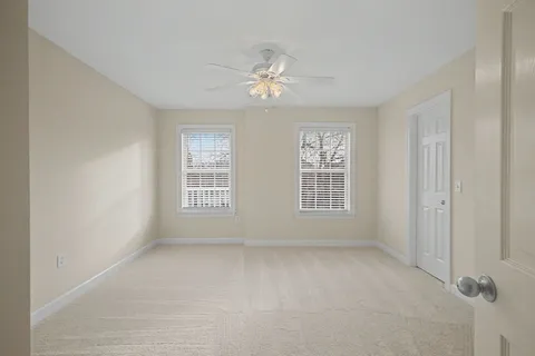 a living room with furniture a flat screen tv and a large window