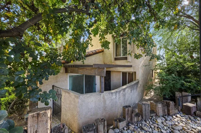 a view of a house with a tree