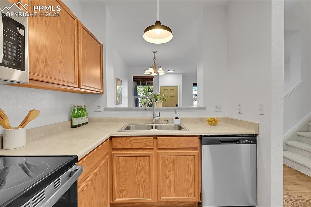 6232 Sierra Grande Point Colorado Springs, CO 80923 - Photo 11 of 31 a kitchen with a sink and a cabinets