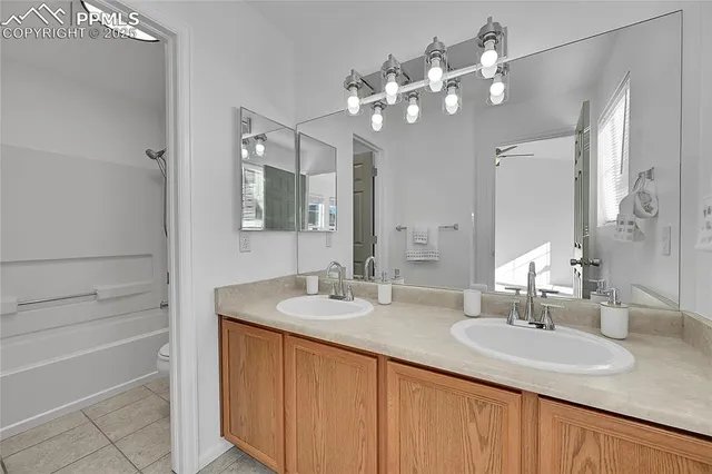 a bathroom with a sink double vanity granite and a mirror